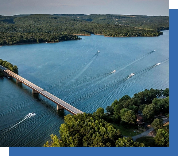 A bridge over water with boats on it.